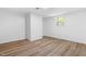 Basement area with laminate wood flooring and a bright window at 4349 Pickwick Dr, Raleigh, NC 27613