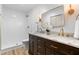 Bathroom featuring double vanity, walk-in shower, and elegant fixtures at 4349 Pickwick Dr, Raleigh, NC 27613