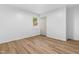 Bright bedroom featuring wood-look floors, a double door closet, and a window at 4349 Pickwick Dr, Raleigh, NC 27613
