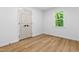 Bright bedroom with wood-look floors, a double door closet, and a window at 4349 Pickwick Dr, Raleigh, NC 27613