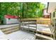 Large deck with railing, built-in benches, and backyard shed offers relaxing outdoor space at 4349 Pickwick Dr, Raleigh, NC 27613
