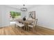 Bright dining room boasts modern lighting, backyard views, and stylish furniture, ideal for meals and entertaining at 4349 Pickwick Dr, Raleigh, NC 27613