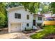 Charming two-story home with a one car garage, black framed windows, manicured lawn, and a brick garden at 4349 Pickwick Dr, Raleigh, NC 27613