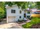 Charming two-story home with a one car garage, black framed windows, manicured lawn, and a brick garden at 4349 Pickwick Dr, Raleigh, NC 27613