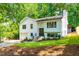 Two-story home boasts a white exterior, black window trim, attached garage and mature trees at 4349 Pickwick Dr, Raleigh, NC 27613
