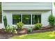 View of home's exterior with modern dark frame windows, and newly landscaped garden at 4349 Pickwick Dr, Raleigh, NC 27613