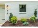 Home exterior showcasing address, updated outdoor lighting, and manicured landscaping around the perimeter at 4349 Pickwick Dr, Raleigh, NC 27613