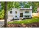 Beautifully landscaped front yard of a modern home with fresh paint and a two-car garage at 4349 Pickwick Dr, Raleigh, NC 27613