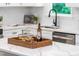 Close-up showcasing the island, complete with wine bottle, glasses, and quartz countertops at 4349 Pickwick Dr, Raleigh, NC 27613