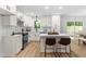 Modern kitchen with white cabinets, stainless steel appliances, and a center island with seating at 4349 Pickwick Dr, Raleigh, NC 27613