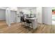 Bright kitchen features white cabinets, stainless steel appliances, and a central island with bar seating at 4349 Pickwick Dr, Raleigh, NC 27613