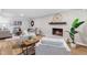 Inviting living room with brick fireplace, white painted walls, and modern furnishings at 4349 Pickwick Dr, Raleigh, NC 27613