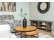 Stylish living room featuring a unique round coffee table and a decorative wall mirror at 4349 Pickwick Dr, Raleigh, NC 27613