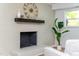 Living room featuring a brick fireplace, dark wood mantle and decor at 4349 Pickwick Dr, Raleigh, NC 27613