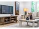 Inviting living room with entertainment center, sleek TV, and comfortable seating, perfect for relaxation at 4349 Pickwick Dr, Raleigh, NC 27613