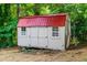 Exterior view of the well-maintained backyard storage shed featuring a bright red roof at 4349 Pickwick Dr, Raleigh, NC 27613