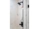 Elegant shower features a rainfall shower head, black fixtures, and white marble style tile at 4349 Pickwick Dr, Raleigh, NC 27613