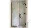 Modern bathroom shower featuring marble-look tile and black fixtures at 4349 Pickwick Dr, Raleigh, NC 27613