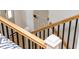 Staircase with wood railing, black metal balusters, and carpeted treads at 4349 Pickwick Dr, Raleigh, NC 27613