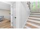 Entryway with staircase featuring wood treads and black metal balusters at 4349 Pickwick Dr, Raleigh, NC 27613