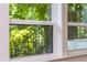 Window with view of green outdoor plants and iron railing at 4349 Pickwick Dr, Raleigh, NC 27613