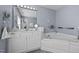 Well-lit bathroom with double vanity, bathtub, and tile flooring at 4600 Landover Dale Dr, Raleigh, NC 27616