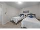 Bright bedroom featuring twin beds, carpet, and neutral paint at 4600 Landover Dale Dr, Raleigh, NC 27616