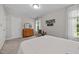 Bright bedroom featuring natural light, artwork, a dresser, and wood furniture at 4600 Landover Dale Dr, Raleigh, NC 27616