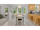 Charming dining area with tiled floors, chandelier, and large windows with backyard views at 4600 Landover Dale Dr, Raleigh, NC 27616