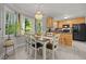 Inviting eat-in kitchen features a chandelier, dining table and seating, and yard views at 4600 Landover Dale Dr, Raleigh, NC 27616