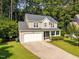Traditional two-story home featuring an attached garage, and lush green lawn at 4600 Landover Dale Dr, Raleigh, NC 27616
