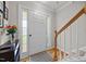 Inviting foyer with wood flooring, stairway, and frosted sidelight windows at 4600 Landover Dale Dr, Raleigh, NC 27616