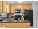 Bright kitchen features light wood cabinets, stainless appliances, and open breakfast bar area at 4600 Landover Dale Dr, Raleigh, NC 27616
