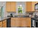 Warm kitchen showcases light wood cabinets, a stainless steel sink, and a mosaic backsplash at 4600 Landover Dale Dr, Raleigh, NC 27616