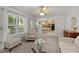 Cozy living room with plush seating, bright windows, and an open view into the dining area and kitchen at 4600 Landover Dale Dr, Raleigh, NC 27616