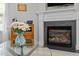Cozy living room with a fireplace and a glass coffee table with fresh flowers at 4600 Landover Dale Dr, Raleigh, NC 27616