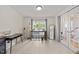 Well-lit office features tiled floors, a window desk, a mannequin, and French doors leading outside at 4600 Landover Dale Dr, Raleigh, NC 27616