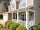 Inviting front porch with a cozy seating area and beautifully landscaped front yard at 4600 Landover Dale Dr, Raleigh, NC 27616