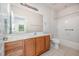 Bathroom featuring wood vanity with double sink, tile floor and a shower and bath combo at 4622 Ivy Blossom Ln, Raleigh, NC 27604