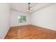 Large bedroom with tray ceiling, wood floors, and a window at 4622 Ivy Blossom Ln, Raleigh, NC 27604