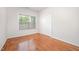 Bedroom features hardwood floors, a large window and a large double door closet at 4622 Ivy Blossom Ln, Raleigh, NC 27604