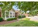 Charming home exterior featuring a well-maintained lawn, mature trees, and brick accents at 4622 Ivy Blossom Ln, Raleigh, NC 27604
