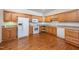 Well-equipped kitchen features wooden cabinets, modern appliances, and hardwood flooring at 4622 Ivy Blossom Ln, Raleigh, NC 27604