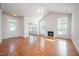 Bright living room features a fireplace, ceiling fan, and gleaming hardwood floors at 4622 Ivy Blossom Ln, Raleigh, NC 27604