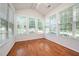 Sunroom with many windows offering natural light and hardwood flooring at 4622 Ivy Blossom Ln, Raleigh, NC 27604