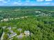 Drone view of homes nestled in a vibrant green forest landscape on a bright day at 4831 Crestmore Rd # 202, Raleigh, NC 27612