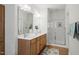 Bathroom featuring a glass-enclosed shower, a large mirror, and double sinks at 4831 Crestmore Rd # 202, Raleigh, NC 27612