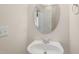 Small bathroom features an oval mirror and a white porcelain sink at 4831 Crestmore Rd # 202, Raleigh, NC 27612
