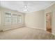 Bedroom with carpet and a ceiling fan and windows allowing natural light at 4831 Crestmore Rd # 202, Raleigh, NC 27612