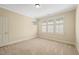 Bright bedroom featuring neutral carpet and trim and large windows for ample natural light at 4831 Crestmore Rd # 202, Raleigh, NC 27612